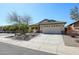 Charming single-story home with a two car garage, xeriscape landscaping, and neutral color palette at 28604 N 21St Ln, Phoenix, AZ 85085