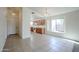 Bright kitchen and dining area with tile flooring, white walls, and wooden cabinetry at 28604 N 21St Ln, Phoenix, AZ 85085