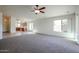 Open concept living room with carpeted floors and natural light, adjacent to the kitchen at 28604 N 21St Ln, Phoenix, AZ 85085