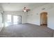 Carpeted living room with large window and ceiling fan at 28604 N 21St Ln, Phoenix, AZ 85085
