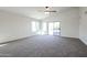 Spacious living area featuring vaulted ceiling, fan, and sliding glass door at 28604 N 21St Ln, Phoenix, AZ 85085