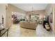 Bright and airy living room with tile floors and an open layout to the kitchen and dining area at 3327 N 163Rd Dr, Goodyear, AZ 85395