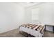 Simple bedroom features carpet, window with blinds, and a comfortable bed at 34924 N 30Th Ave, Phoenix, AZ 85086