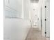 Bright upstairs hallway with carpeted floor, white walls, and natural light from the window at 34924 N 30Th Ave, Phoenix, AZ 85086
