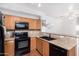 The kitchen features wood cabinets, granite countertops, black appliances, and a double sink at 34924 N 30Th Ave, Phoenix, AZ 85086