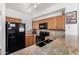 Traditional kitchen with wood cabinets, granite countertops, black appliances, and tile backsplash at 34924 N 30Th Ave, Phoenix, AZ 85086