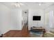 Bright living room with hardwood floors, ceiling fan and a view into the hallway and bathroom at 34924 N 30Th Ave, Phoenix, AZ 85086