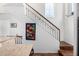 Bright staircase features wood stairs, iron railing, colorful wall hanging, and high windows at 34924 N 30Th Ave, Phoenix, AZ 85086