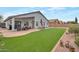 Expansive backyard featuring a well-manicured lawn and patio area, perfect for outdoor activities and gatherings at 35282 N Shorthorn Trl, San Tan Valley, AZ 85143