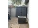 Functional backyard with storage shed, AC unit, and a mix of gravel and brick landscaping elements at 35282 N Shorthorn Trl, San Tan Valley, AZ 85143