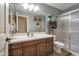 Bathroom featuring a shower, wood vanity, towels, and neutral wall color at 35282 N Shorthorn Trl, San Tan Valley, AZ 85143