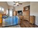 Bedroom featuring a wood bed, TV, and wood furnishings with a ceiling fan at 35282 N Shorthorn Trl, San Tan Valley, AZ 85143