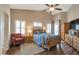 Light and bright bedroom with a wood bed, neutral walls, and shuttered windows at 35282 N Shorthorn Trl, San Tan Valley, AZ 85143