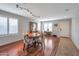 Spacious dining area showcasing hardwood floors, a wooden table, seating for four, and plantation shutters at 35282 N Shorthorn Trl, San Tan Valley, AZ 85143