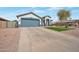 Attractive single-Gathering home with a spacious driveway, well-maintained lawn, and inviting curb appeal at 35282 N Shorthorn Trl, San Tan Valley, AZ 85143