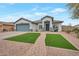 Charming single-story home with well-manicured front yard and appealing walkway leading to the entrance at 35282 N Shorthorn Trl, San Tan Valley, AZ 85143
