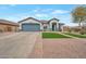 Beautiful single-story home featuring a two-car garage, landscaped front yard, and charming curb appeal at 35282 N Shorthorn Trl, San Tan Valley, AZ 85143