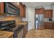 Well-appointed kitchen with stainless steel appliances, granite countertops, and ample cabinet space at 35282 N Shorthorn Trl, San Tan Valley, AZ 85143