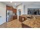 Modern kitchen featuring granite countertops, tile backsplash, and stainless steel appliances at 35282 N Shorthorn Trl, San Tan Valley, AZ 85143
