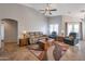 Comfortable living room featuring high ceilings, tile floors, ample seating, and a ceiling fan at 35282 N Shorthorn Trl, San Tan Valley, AZ 85143
