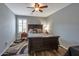 Comfortable main bedroom with a ceiling fan, stylish rug, and a window providing natural light at 35282 N Shorthorn Trl, San Tan Valley, AZ 85143