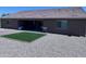 Backyard features gravel landscaping, an artificial grass area, and a covered patio at 3829 N Princeton Ln, Casa Grande, AZ 85122