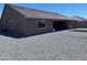 The backyard featuring gravel landscaping, covered patio, and artificial turf at 3829 N Princeton Ln, Casa Grande, AZ 85122