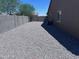 Low-maintenance backyard features gravel landscaping and block fencing for added privacy at 3829 N Princeton Ln, Casa Grande, AZ 85122
