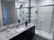 Modern bathroom with a granite countertop vanity and sleek glass-enclosed shower at 3829 N Princeton Ln, Casa Grande, AZ 85122