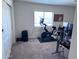 Bright bedroom with a Peloton bike, desk, and ample space for working out or home office at 3829 N Princeton Ln, Casa Grande, AZ 85122
