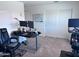 Home office with a sit stand desk, Peloton bike, dual monitor display and rolling office chair at 3829 N Princeton Ln, Casa Grande, AZ 85122