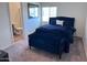 Stylish bedroom with a dark bed frame, plush bedding, and a view into a bathroom at 3829 N Princeton Ln, Casa Grande, AZ 85122