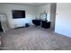 Spacious carpeted bedroom with a makeup vanity, wall-mounted television, and large mirror at 3829 N Princeton Ln, Casa Grande, AZ 85122