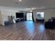 Spacious living room with wood-look flooring, a ceiling fan, and plenty of natural light at 3829 N Princeton Ln, Casa Grande, AZ 85122