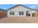 View of the back of the house showing the windows and backyard of the property at 3889 S 233Rd Ln, Buckeye, AZ 85326
