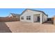 View of the back of the house showing the windows and backyard of the property at 3889 S 233Rd Ln, Buckeye, AZ 85326
