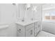 Bright bathroom with double vanity, neutral paint, with bright countertops and access to the main bedroom at 3889 S 233Rd Ln, Buckeye, AZ 85326