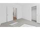 Clean bedroom with light gray carpet and an open door leading into the hall at 3889 S 233Rd Ln, Buckeye, AZ 85326