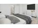 The spacious bedroom boasts a large window and TV with a view of an ensuite bathroom with bright countertops at 3889 S 233Rd Ln, Buckeye, AZ 85326