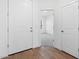 Welcoming entryway with wood-look floors leading to an open doorway at 3889 S 233Rd Ln, Buckeye, AZ 85326