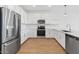 Modern kitchen with stainless steel appliances, subway tile backsplash, and wood flooring at 3889 S 233Rd Ln, Buckeye, AZ 85326