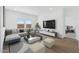 Bright living room with contemporary furniture, large windows, and stylish decor at 3889 S 233Rd Ln, Buckeye, AZ 85326