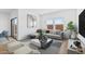 A brightly lit living room features a comfortable sectional couch, modern art and sliding glass doors at 3889 S 233Rd Ln, Buckeye, AZ 85326