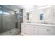 Bright bathroom featuring double vanity with stone counters and a glass enclosed shower at 3914 E Surrey Ave, Phoenix, AZ 85032