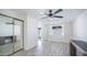 Bright bedroom with wood-look floors, modern ceiling fan and double doors to patio at 3914 E Surrey Ave, Phoenix, AZ 85032