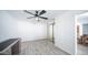 Bright bedroom with wood-look floors, modern ceiling fan and closet with mirrored doors at 3914 E Surrey Ave, Phoenix, AZ 85032