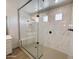 Modern bathroom showcasing glass shower, marble tile, built-in bench, and a calming neutral color palette at 40113 N Alameda Dr, San Tan Valley, AZ 85140