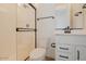 Shower and toilet in a well-lit bathroom with white cabinets at 40113 N Alameda Dr, San Tan Valley, AZ 85140