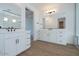 Stylish bathroom featuring double sinks, modern fixtures, and wood tile flooring at 40113 N Alameda Dr, San Tan Valley, AZ 85140