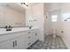 Well-lit bathroom features double sinks, decorative floor, and shower at 40113 N Alameda Dr, San Tan Valley, AZ 85140